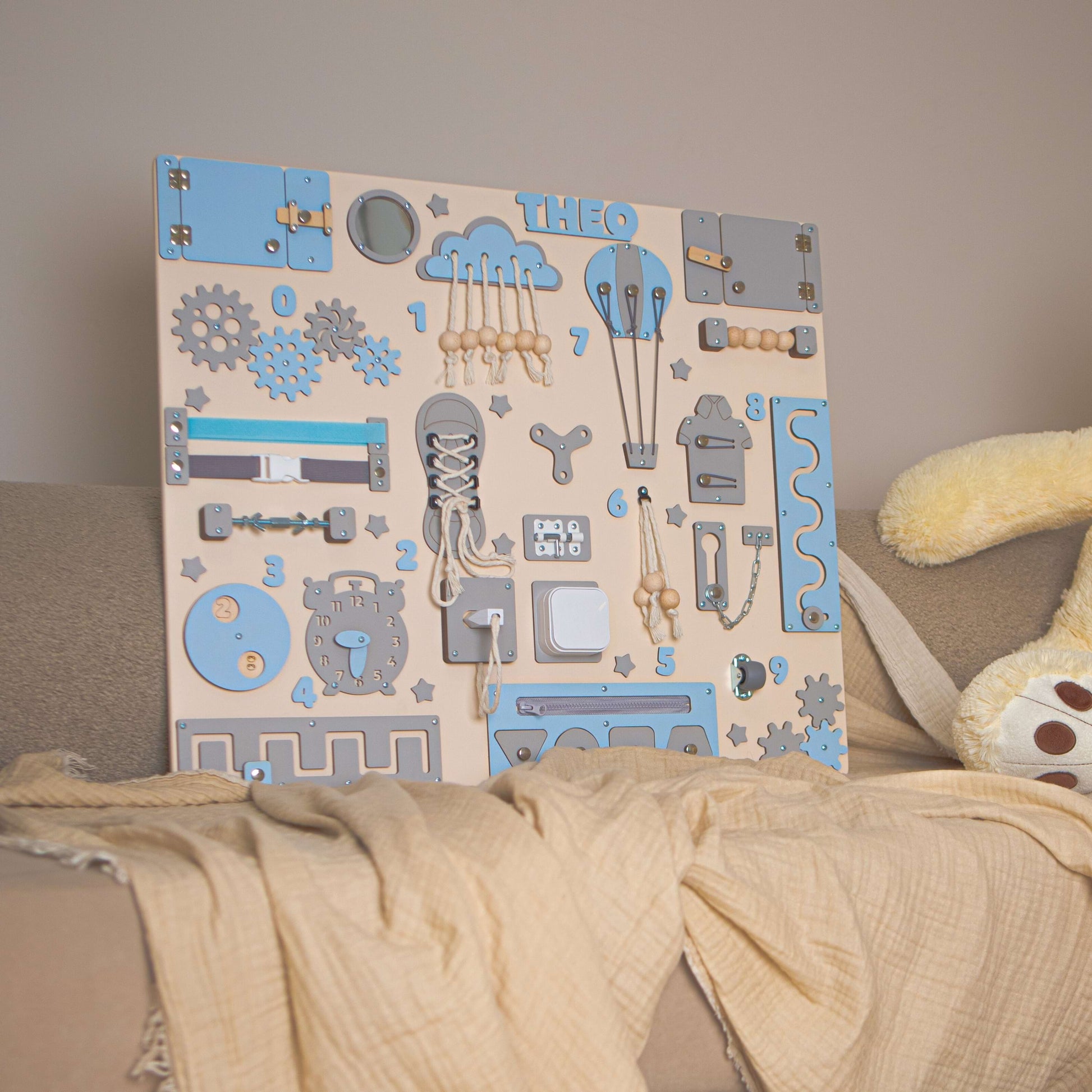 Children's name board with decorative elements on a neutral background