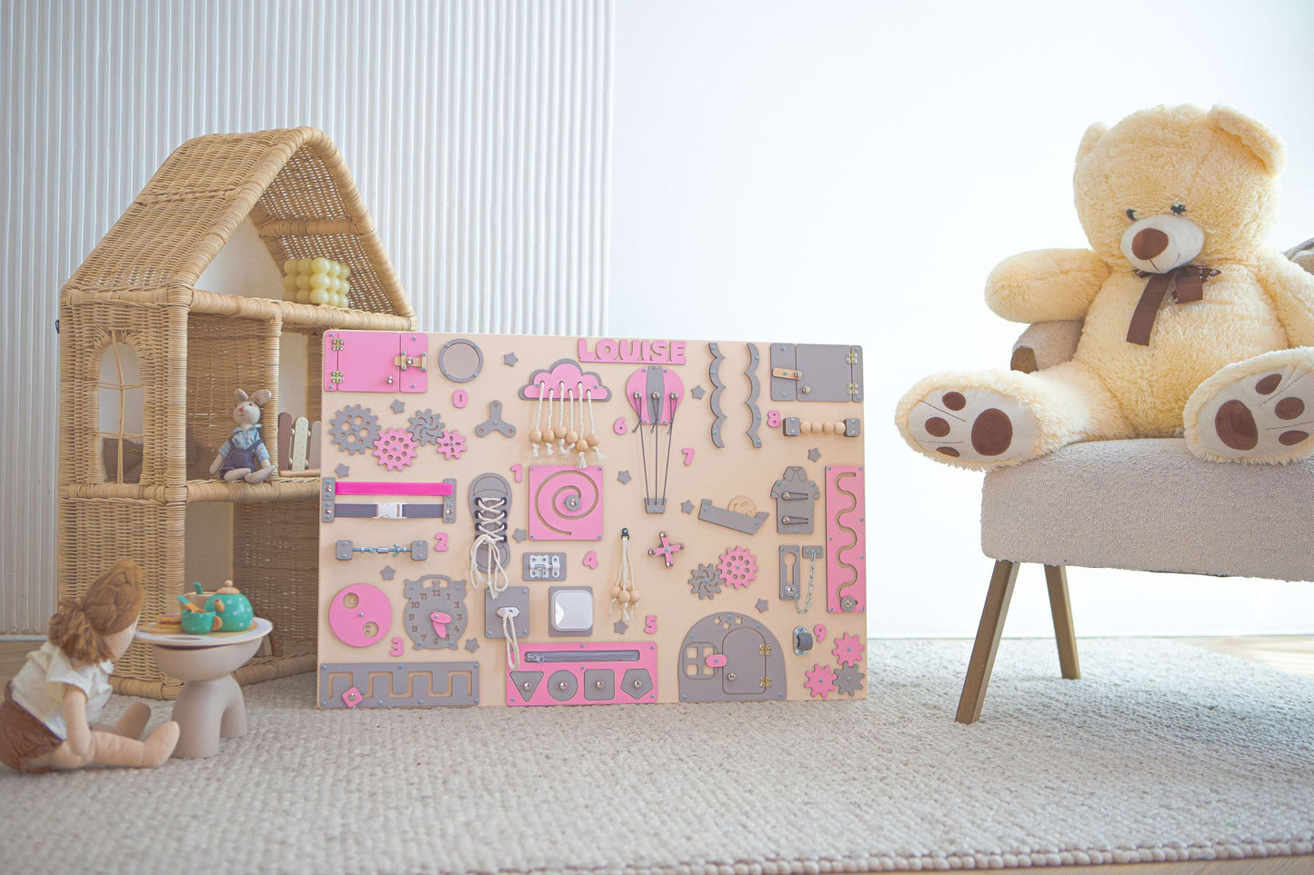 Children's Montessori wall with cartoon designs in a room with toys and furniture.