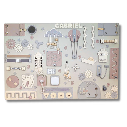 Baby pastel busy board with various educational elements on a white background